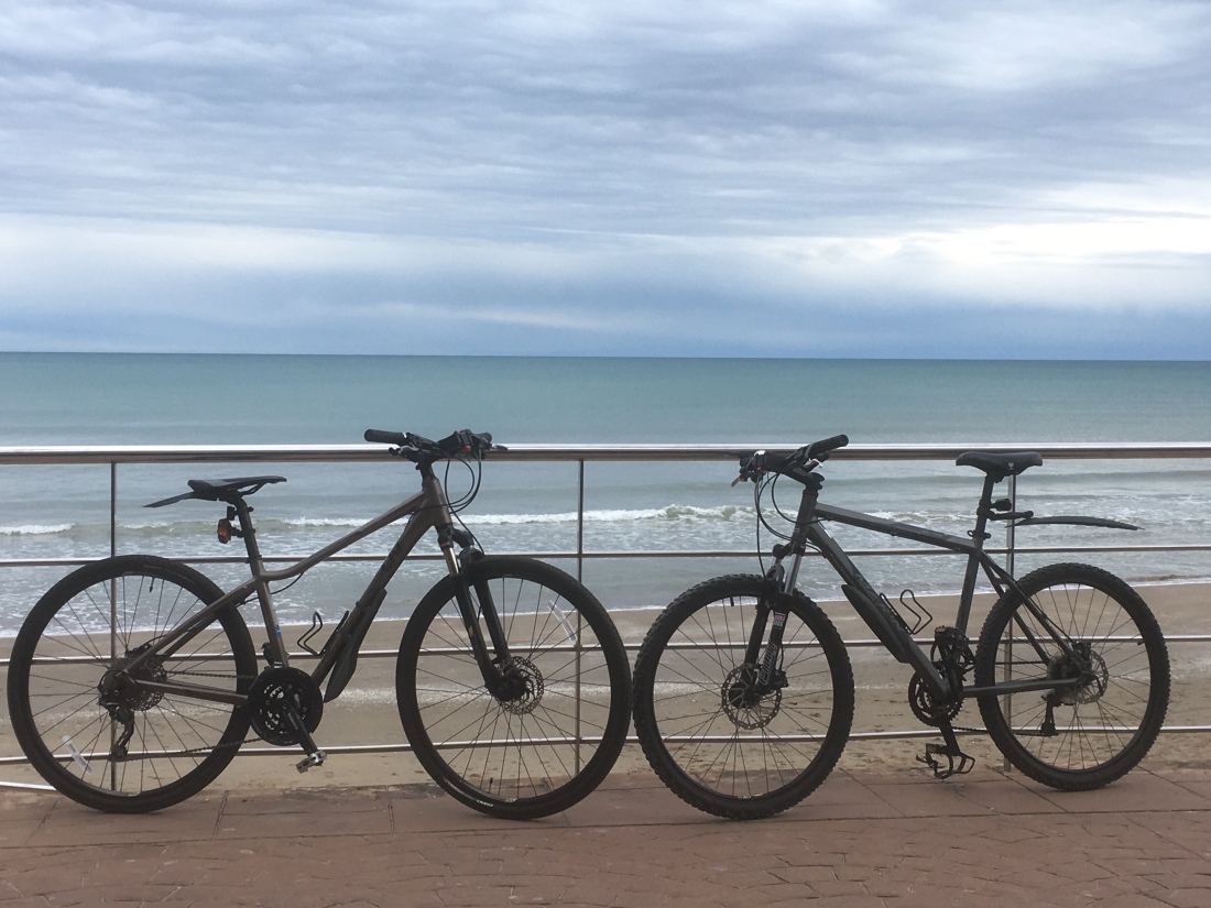 Two mountain bikes by the sea in Spain